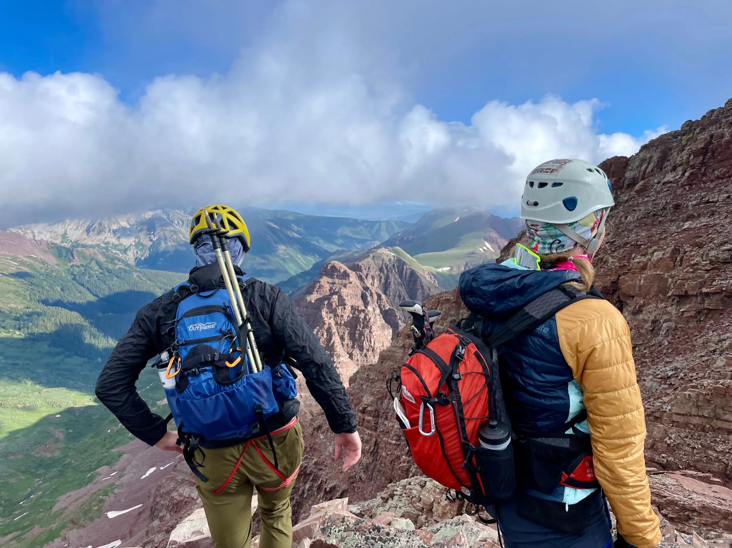 Backpackers wearing OutThere backpacks on a mountain